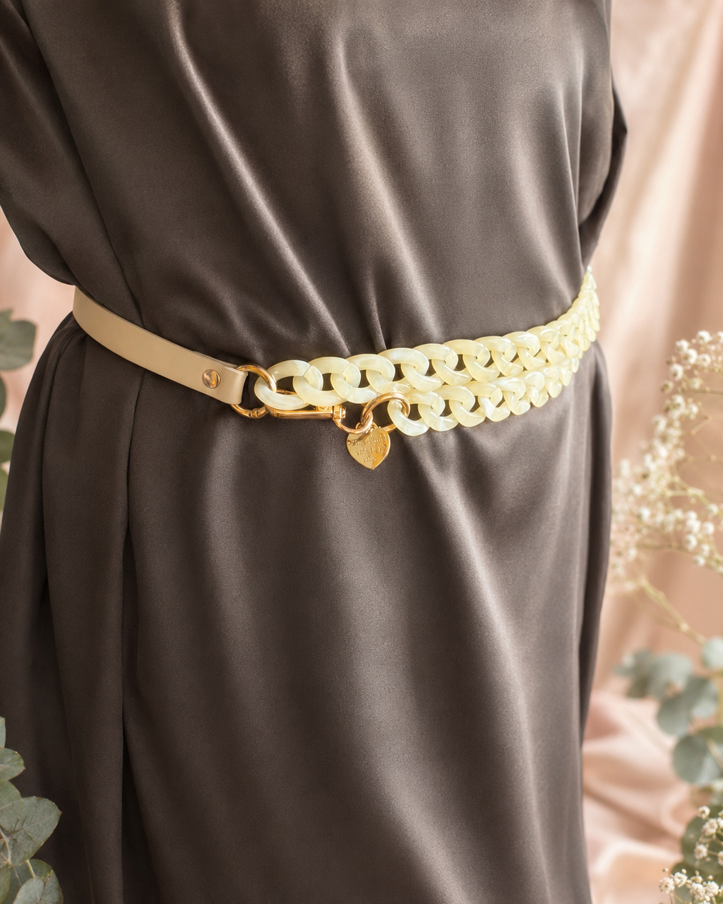 Cream adjustable faux leather and acrylic crossbody phone chain worn as a stylish belt with gold-tone hardware and engraved heart charm.