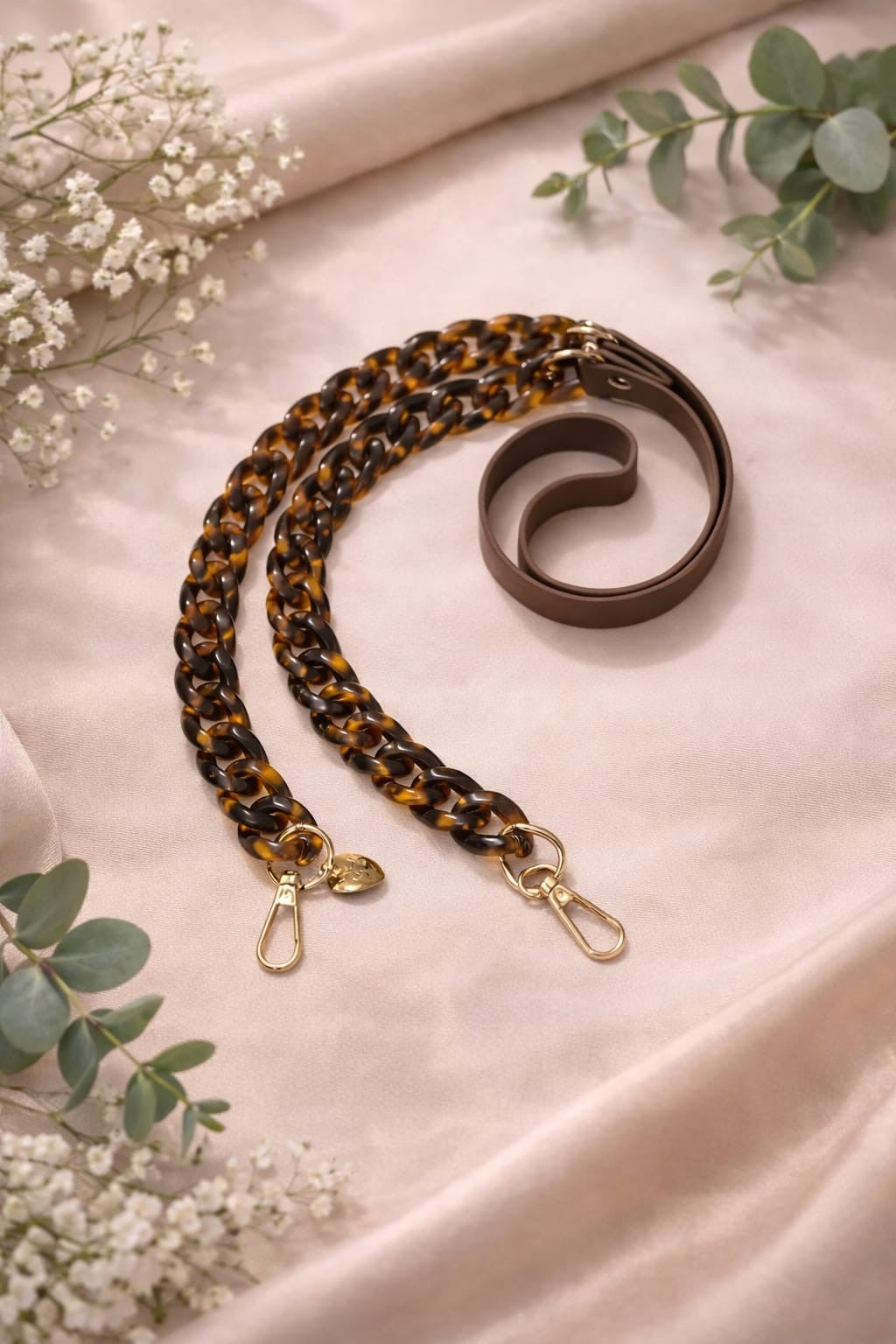 Leopard faux leather and acrylic crossbody phone chain with gold-tone hardware.